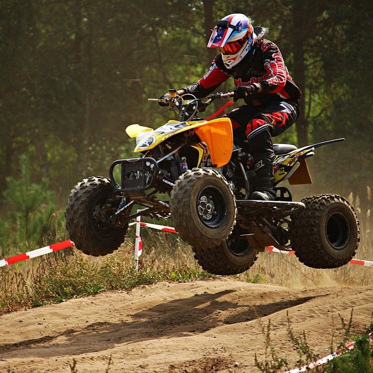 Person Riding ATV on Dirt Road