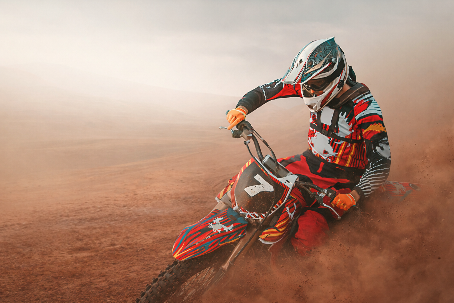 Biker riding a dirtbike in the desert